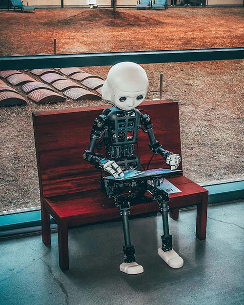 AI Robot Kid at a Park with a Laptop